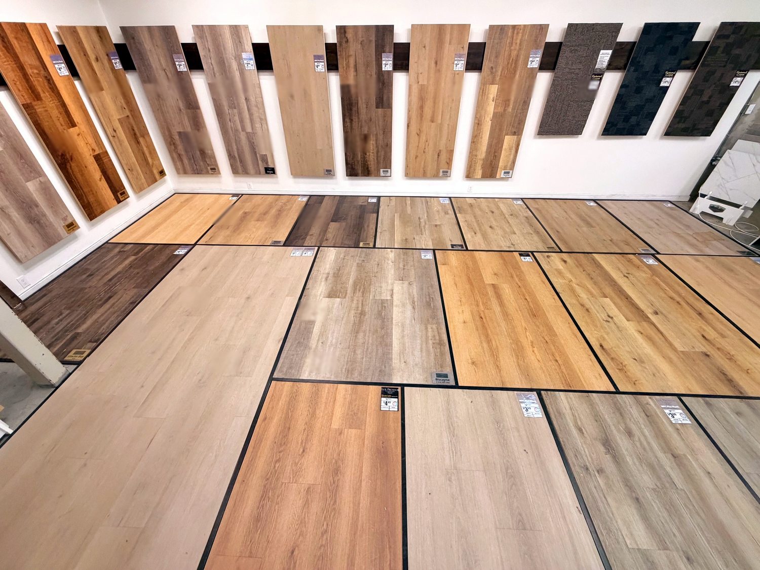 Wood-look laminate and plank flooring display at Taylor Carpets and Flooring